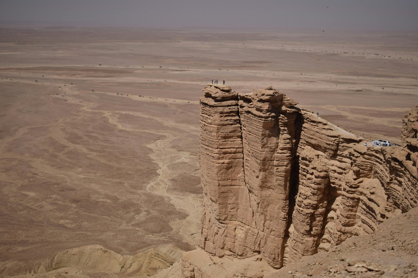 A breathtaking view of the rugged Tuwaiq escarpment rising above the Saudi Arabian desert.